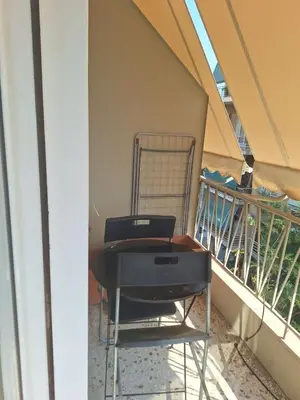 a desk and a chair on a balcony at Cozy renovated flat with balcony in Athens