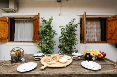 a table with plates of food on top of it at Marousa's Country House 12 minutes from Athens Airport in Koropíon
