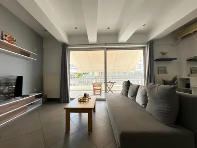 a living room with a couch and a table at 6th Floor Serenity Apartment in Zografou, Athens in Athens