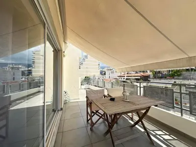 a balcony with a table and a view of a city at 6th Floor Serenity Apartment in Zografou, Athens in Athens