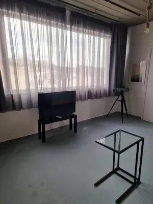 a living room with a television and a glass table at athens parthenon view in Athens