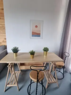 a table and two chairs with potted plants on it at athens parthenon view in Athens