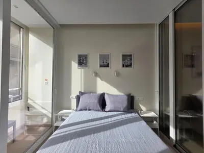 a bedroom with a bed and a large window at Syntagma Elegance on Ermou in Athens