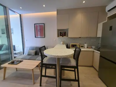 a kitchen and living room with a table and chairs at Syntagma Elegance on Ermou in Athens