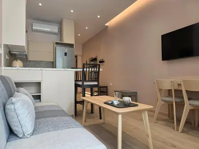 a living room with a couch and a table at Syntagma Elegance on Ermou in Athens