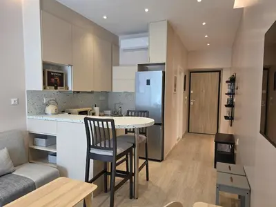 a kitchen and living room with a table and chairs at Syntagma Elegance on Ermou in Athens