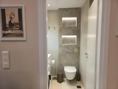 a bathroom with a toilet and a picture of a bird at Syntagma Elegance on Ermou in Athens
