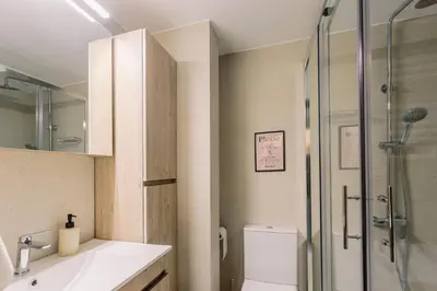 a bathroom with a shower and a toilet and a sink at Cozy 2 Bedroom Apartment Gaia by Philoxenia in Athens
