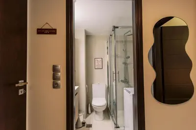 a bathroom with a toilet and a mirror at Cozy 2 Bedroom Apartment Gaia by Philoxenia in Athens