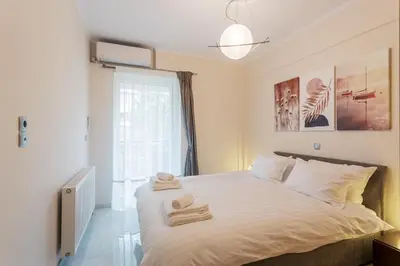 a bedroom with a bed with towels on it at Cozy 2 Bedroom Apartment Gaia by Philoxenia in Athens
