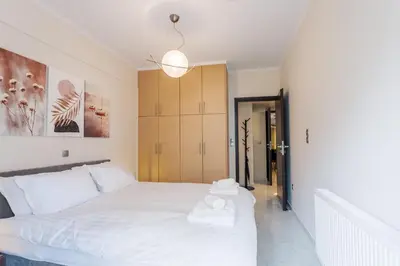 a bedroom with a white bed with towels on it at Cozy 2 Bedroom Apartment Gaia by Philoxenia in Athens