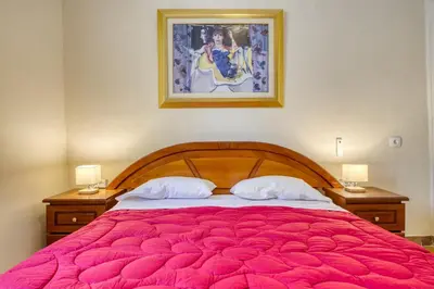 a bedroom with a large bed with a red blanket at Acropolis Vintage Apartment in Athens