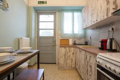 a kitchen with wooden counters and a white door at Acropolis Vintage Apartment in Athens
