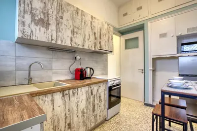 a kitchen with wooden cabinets and a sink at Acropolis Vintage Apartment in Athens