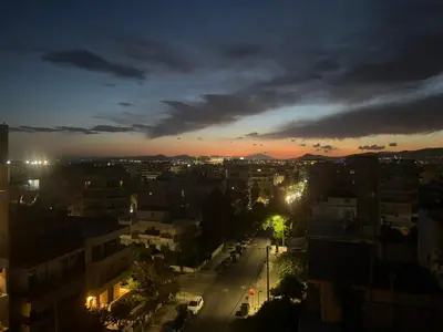 a view of a city at night at Sunlit Panorama Faliro in Athens
