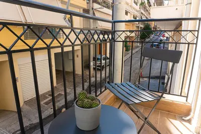 a balcony with a bench and a plant on a table at Elegant Suite - Piraeus in Piraeus