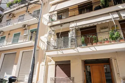 an apartment building with balconies and a door at Elegant Suite - Piraeus in Piraeus