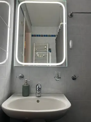 a bathroom with a sink and a mirror at Boubous house in Athens
