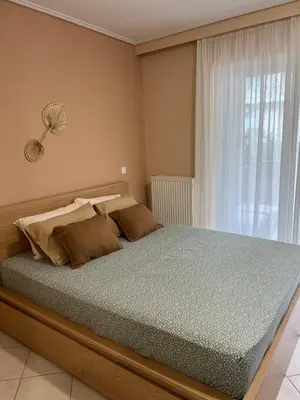 a bedroom with a large bed with a window at Boubous house in Athens
