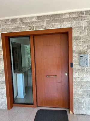 a large wooden door in a brick building at Boubous house in Athens
