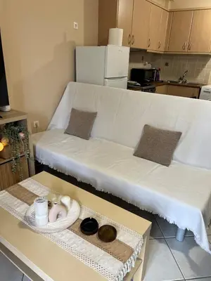 a white couch sitting on a table in a kitchen at Boubous house in Athens