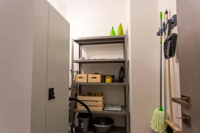 a room with a shelf with boxes on it at Bright 2 Bedroom Apartment Helios by Philoxenia in Athens