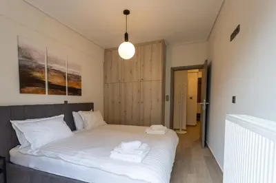 a bedroom with a bed with two towels on it at Bright 2 Bedroom Apartment Helios by Philoxenia in Athens