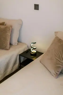 a room with two beds and a table with a lamp at Bright 2 Bedroom Apartment Helios by Philoxenia in Athens