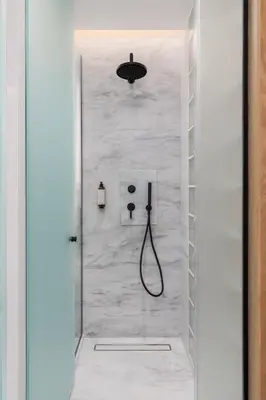 a shower in a bathroom with a white wall at capital house in Athens