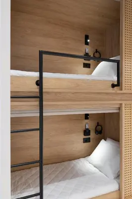 two bunk beds in a room with wood at capital house in Athens