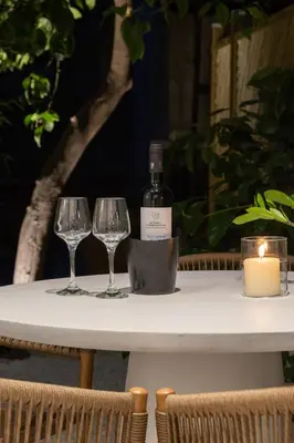 a table with two wine glasses and a bottle of wine at capital house in Athens