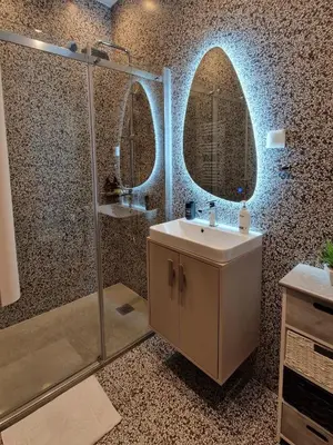 a bathroom with a shower and a sink and a mirror at Athens Central Studios 2 in Athens