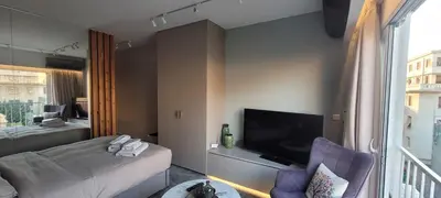a hotel room with a bed and a tv at Athens Central Studios 2 in Athens