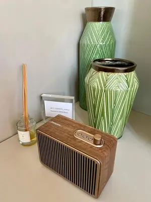a table with a radio and a green vase at Athens Central Studios 2 in Athens