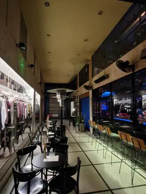 a restaurant with tables and chairs and a bar at Athens Central Studios 2 in Athens