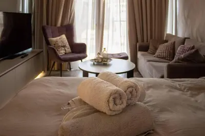 a hotel room with a towel on a bed at Athens Central Studios 2 in Athens