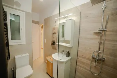 a bathroom with a shower and a toilet and a sink at Luxury&Zen DownTown Apartment by MPS in Athens