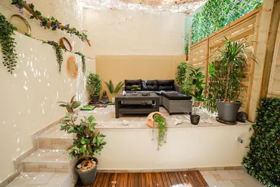 a living room with a couch and many plants at Luxury&Zen DownTown Apartment by MPS in Athens