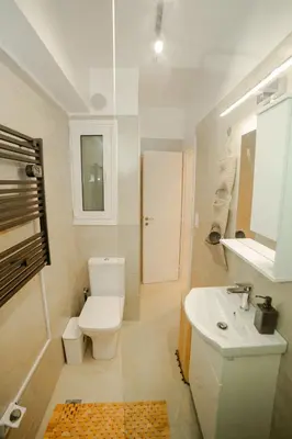 a white bathroom with a toilet and a sink at Luxury&Zen DownTown Apartment by MPS in Athens