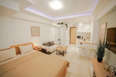 a bedroom with a bed and a living room at Luxury&Zen DownTown Apartment by MPS in Athens