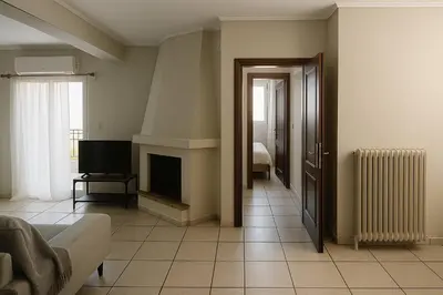 a living room with a fireplace and a television at Apartment for 4 with Acropolis view - Athens 5km Piraeus 5km Metro 5' walk in Piraeus
