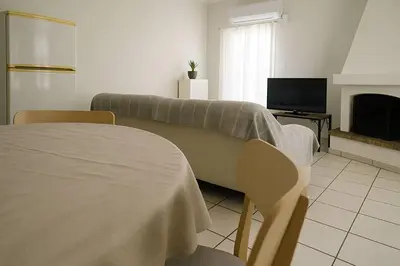 a living room with a couch and a tv at Apartment for 4 with Acropolis view - Athens 5km Piraeus 5km Metro 5' walk in Piraeus
