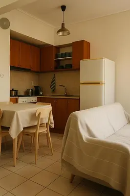 a kitchen with a table and a white refrigerator at Apartment for 4 with Acropolis view - Athens 5km Piraeus 5km Metro 5' walk in Piraeus