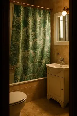 a bathroom with a sink and a shower curtain at Apartment for 4 with Acropolis view - Athens 5km Piraeus 5km Metro 5' walk in Piraeus