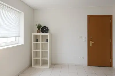 a room with a book shelf and a clock on the wall at Apartment for 4 with Acropolis view - Athens 5km Piraeus 5km Metro 5' walk in Piraeus