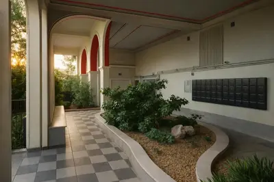 a house with a courtyard with a tree in it at Apartment for 4 with Acropolis view - Athens 5km Piraeus 5km Metro 5' walk in Piraeus