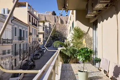 an apartment balcony with plants on a city street at Acropolis Delight Residence II in Athens