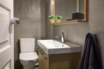 a bathroom with a white sink and a toilet at Acropolis Delight Residence II in Athens
