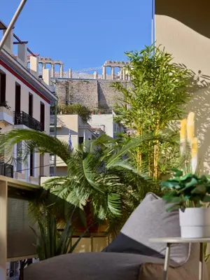a view of a city from a balcony with plants at Acropolis Delight Residence II in Athens
