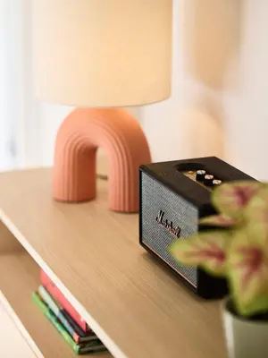 a table with a lamp and a clock on a shelf at Acropolis Delight Residence II in Athens